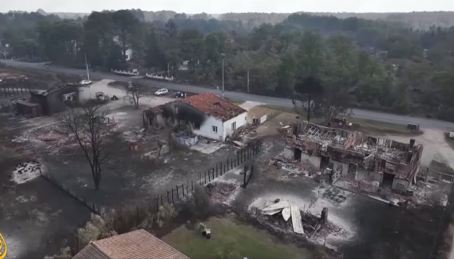 Aerial view of destroyed homes and charred landscape, Bordeaux region.
