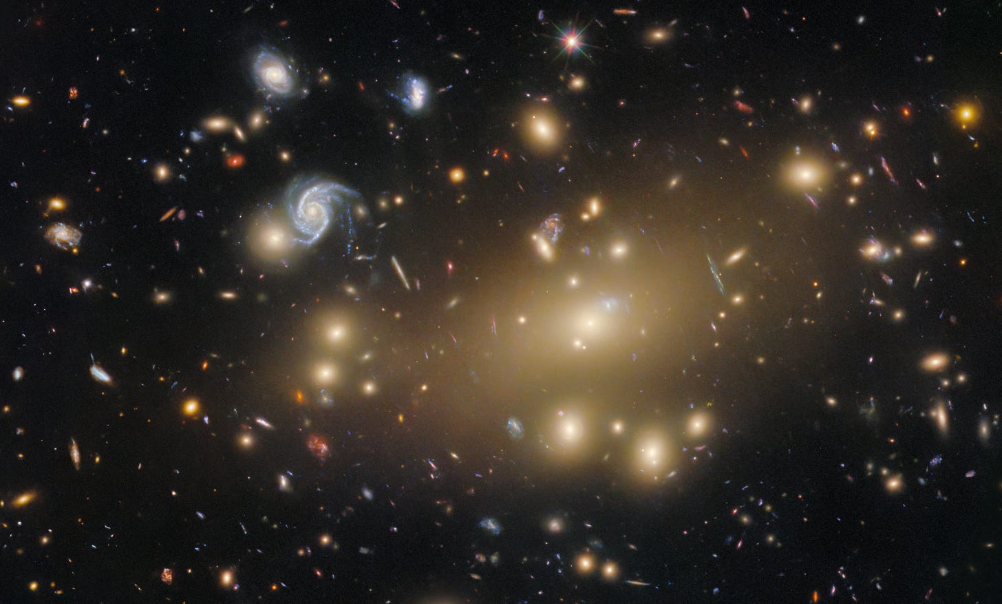 NASA photograph of a cluster of colorful galaxies