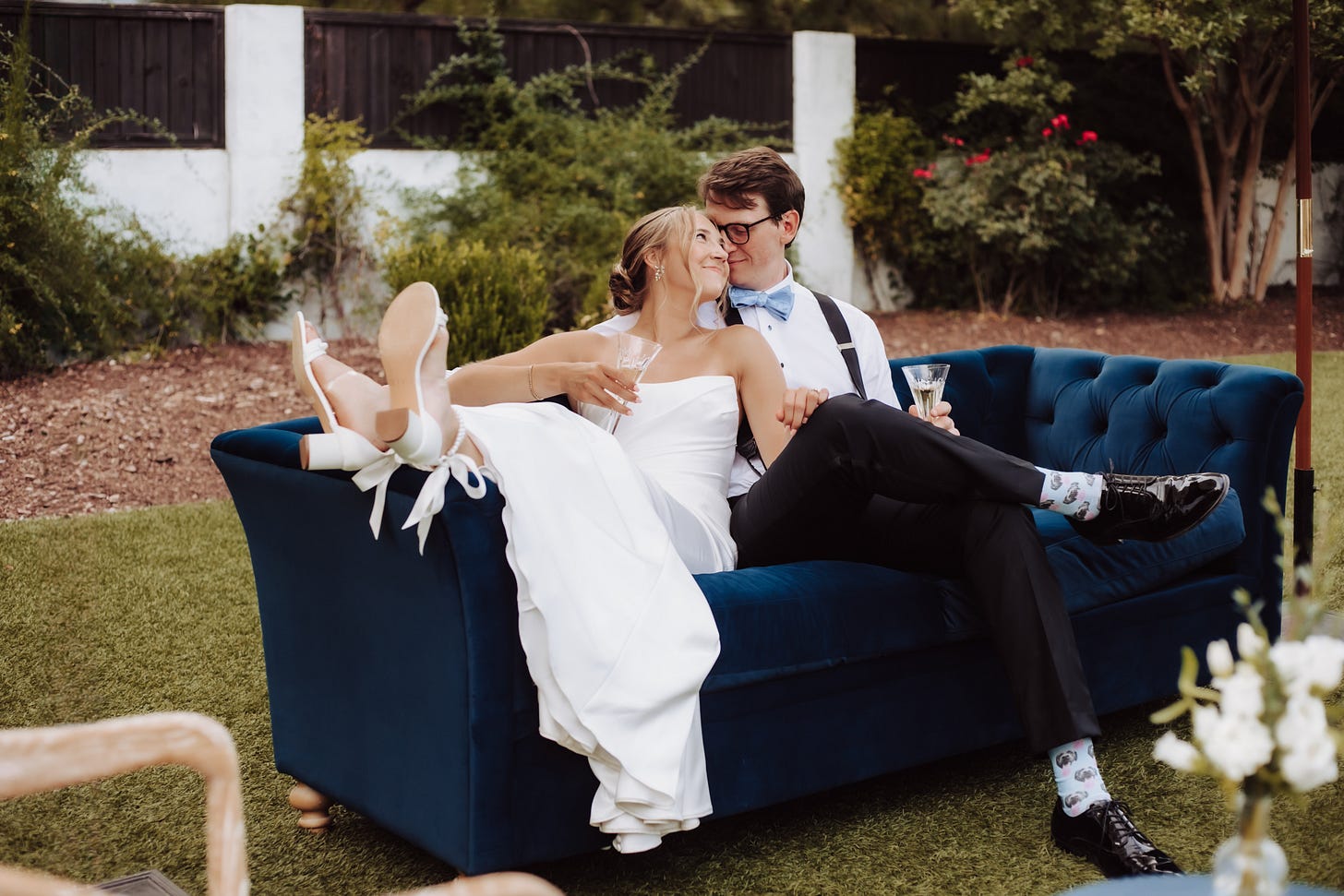 husband and wife dreaming on a blue couch and looking at each other husband and wife dreaming on a blue couch and looking at each other