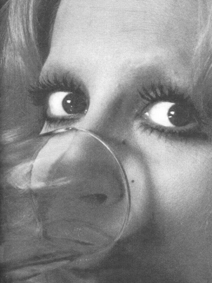 This may contain: a woman with big eyes looking through a magnifying glass This may contain: a woman with big eyes looking through a magnifying glass