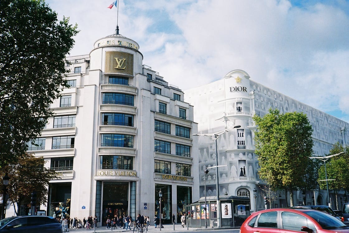 Free Exploring a bustling avenue lined with luxury brand stores and classic architecture. Stock Photo