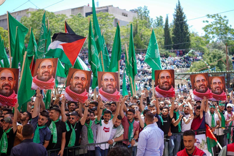 Students waving flags and holding up a portrait of a man Students waving flags and holding up a portrait of a man