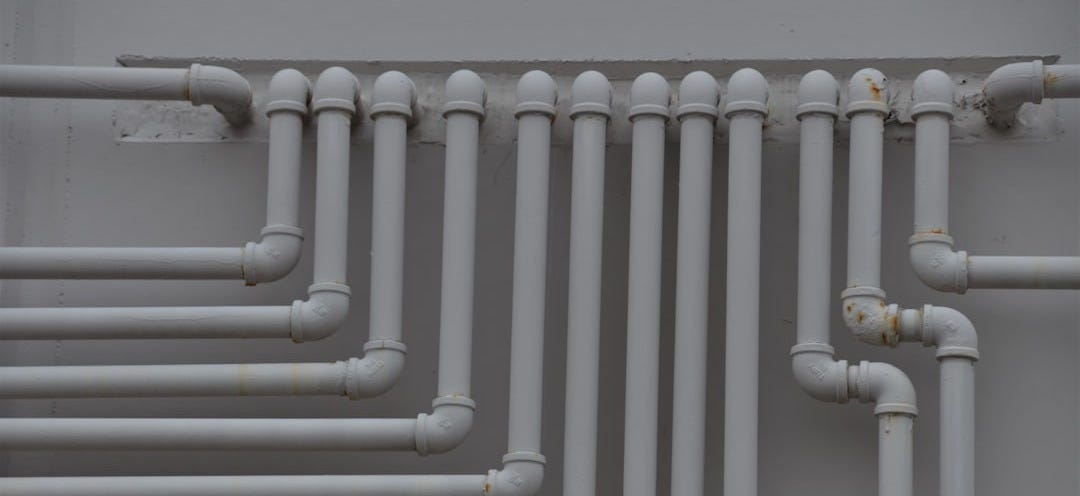 a close up of a bunch of pipes on a wall