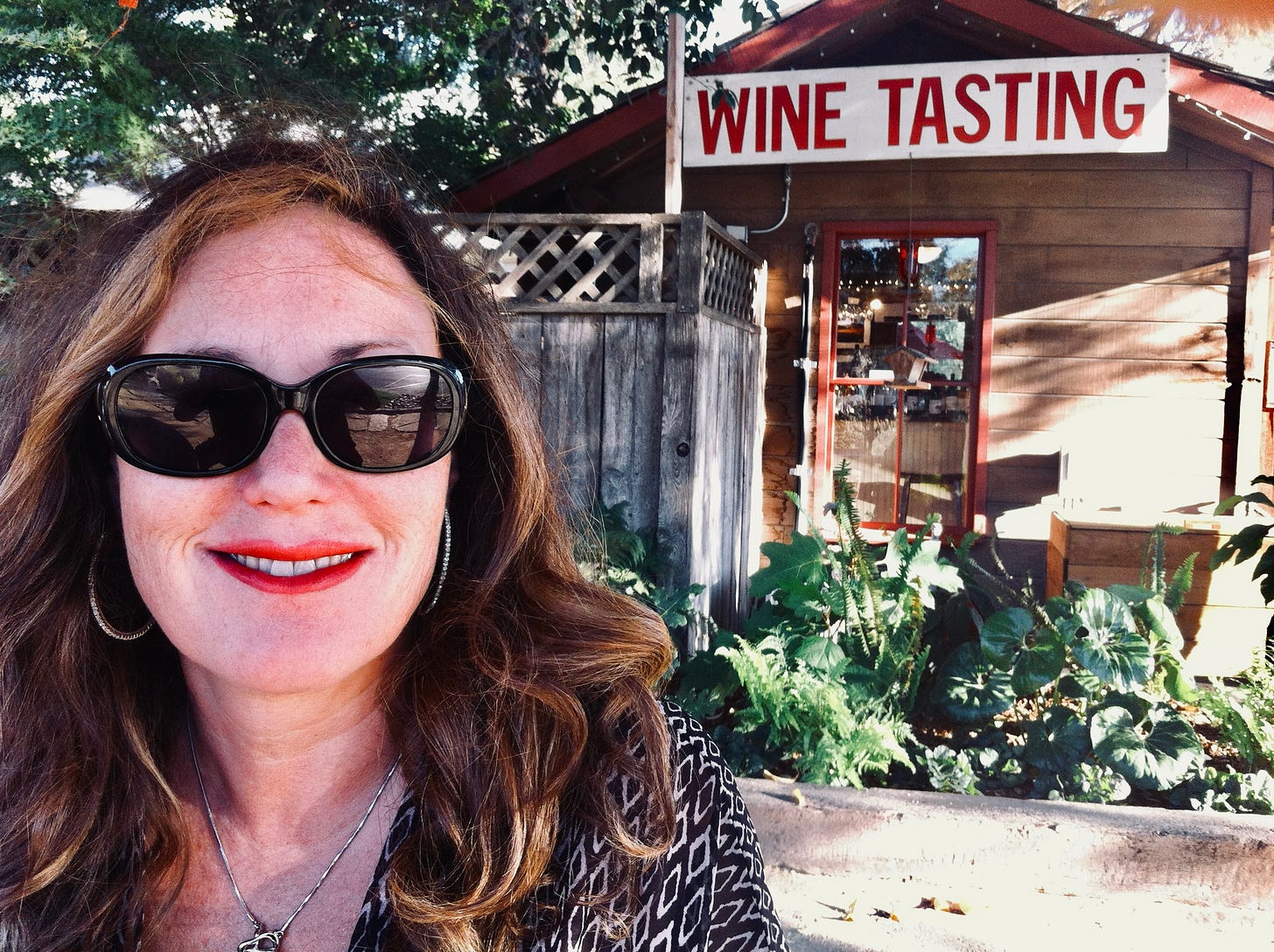 Andrea Tate smiling in front of wine tasting event Andrea Tate smiling in front of wine tasting event
