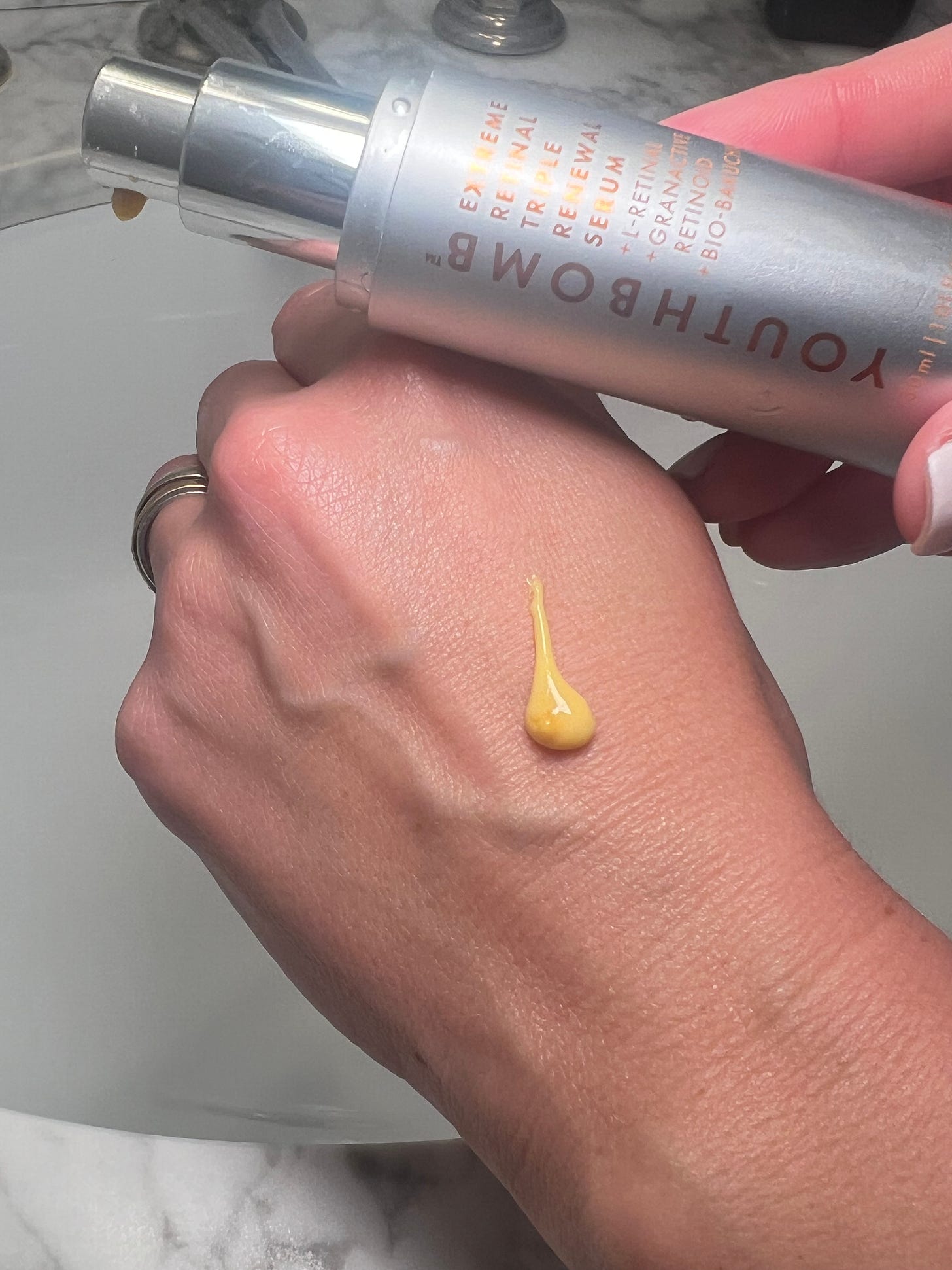 A picture of Beauty Editor Donna Francis holding a bottle of Beauty Pie Youthbomb Extreme Retinal Triple Renewal Serum for The Beauty Ed®