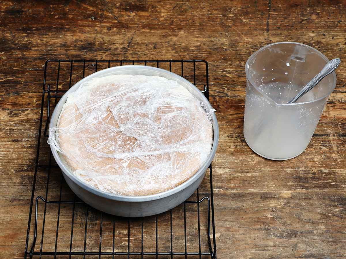 Tres leches cake covered with plastic wrap