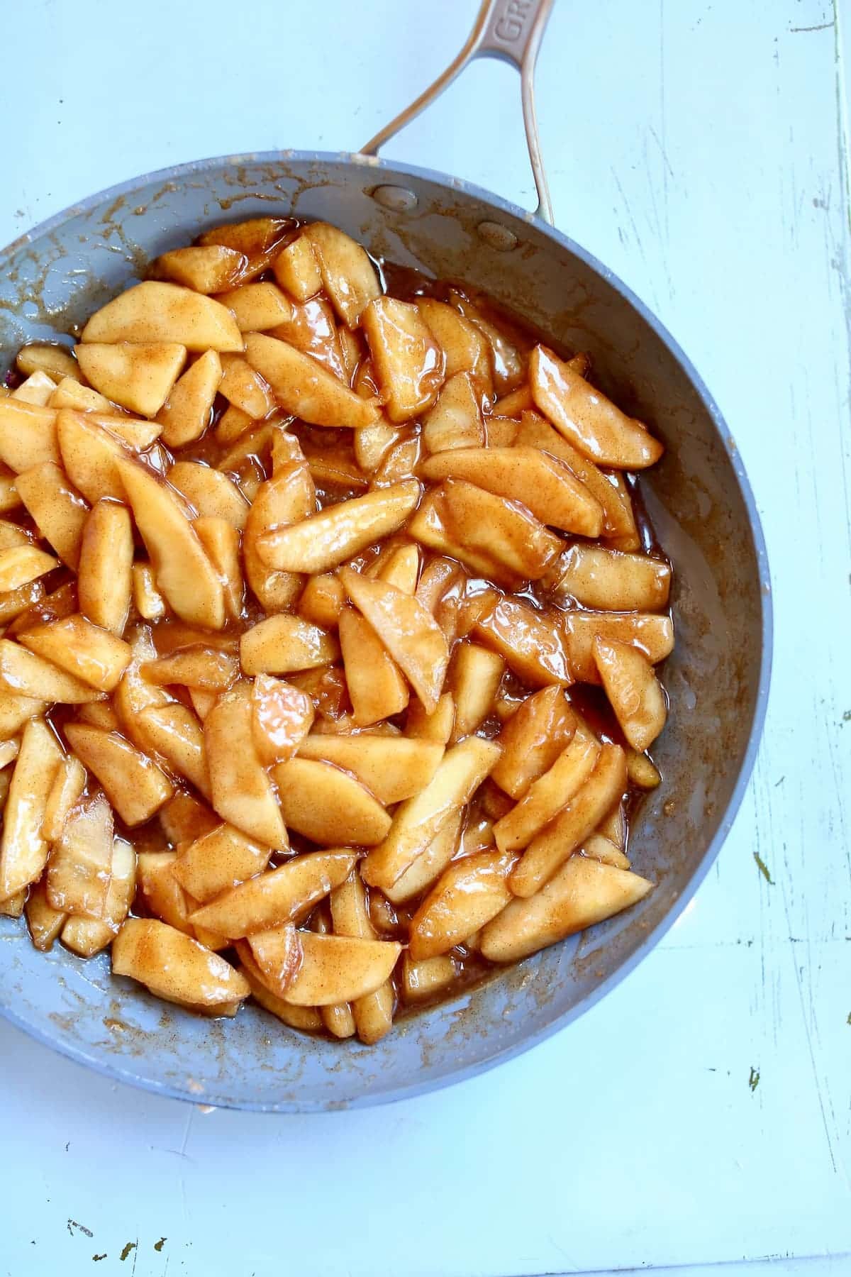 a skillet with apples in it.