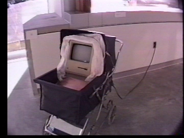 a small computer is swaddled in a baby carriage