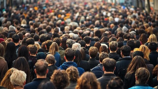 Huge crowds of people standing in a USA city waiting for something to  happen.