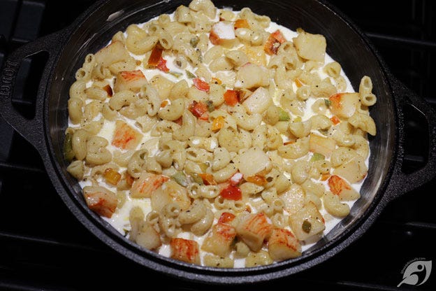 Add half of the combined macaroni, pepper, and lobster mixture to the prepared cast iron skillet to assemble. Pour in the Half-n-Half. Add half of the combined macaroni, pepper, and lobster mixture to the prepared cast iron skillet to assemble. Pour in the Half-n-Half.