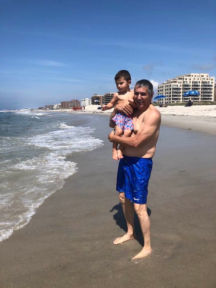 May be an image of 1 person, baby, ocean and beach