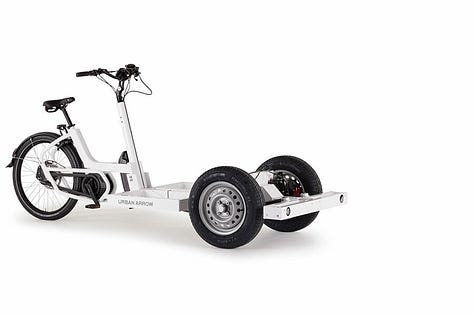 The tender is a tricycle cargobike with two wheels at the front. A gallery of images showing different combinations of Tender cargobikes. One has nothing on, just a platform. Another has a large storage box and another has a large flight case
