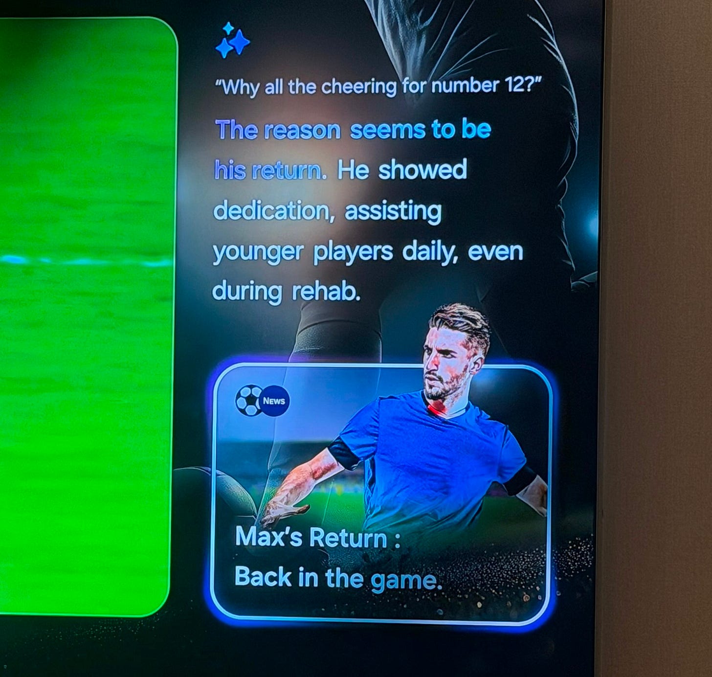 A Samsung TV displays an AI-generated sports context panel explaining why fans are cheering for a player, with a related news card showing a soccer player labeled “Max’s Return: Back in the game.” A Samsung TV displays an AI-generated sports context panel explaining why fans are cheering for a player, with a related news card showing a soccer player labeled “Max’s Return: Back in the game.”