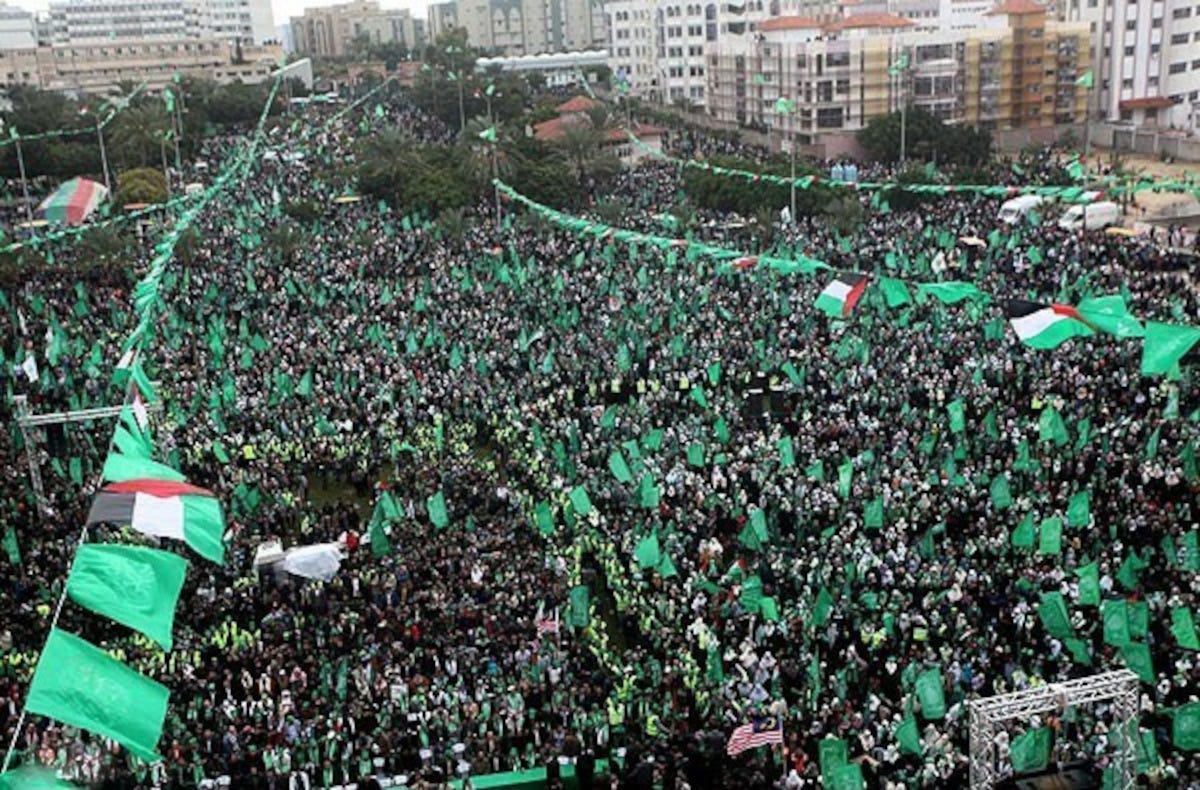 Massive demonstration with people waving green Hamas flags Massive demonstration with people waving green Hamas flags