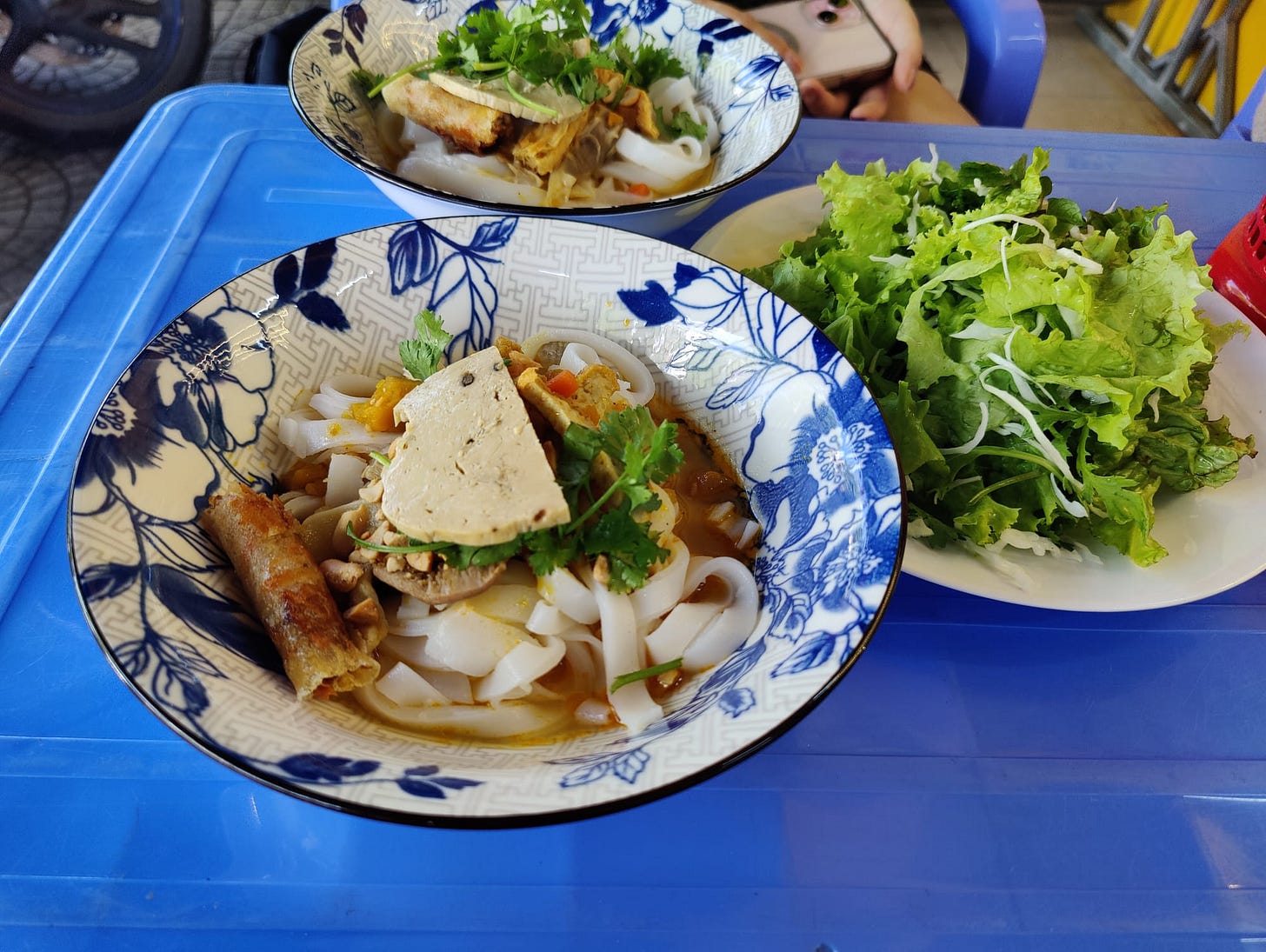 bowls of noodles and springrolls
