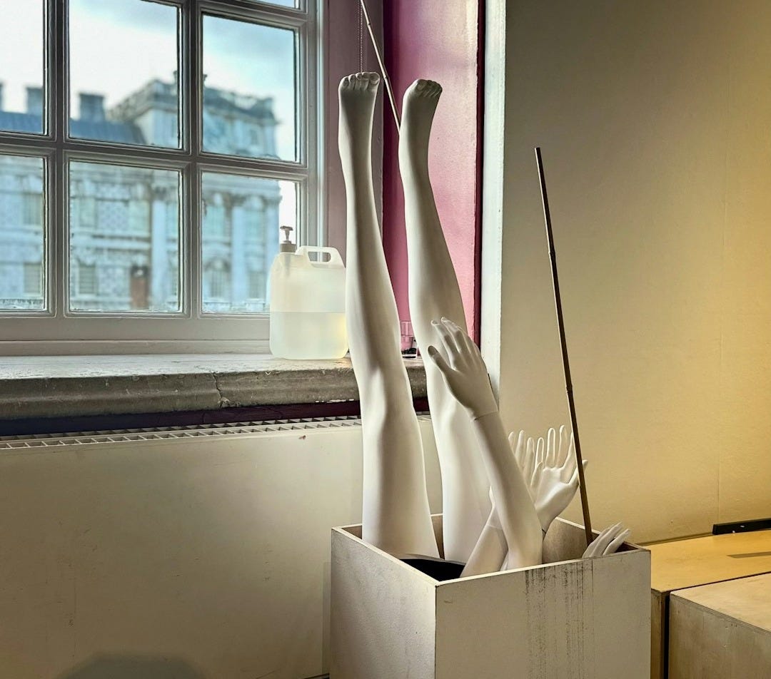 a couple of white vases sitting on top of a box