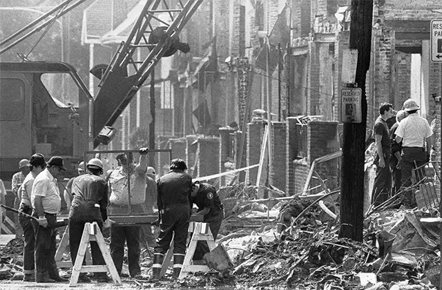 A firefighter stands amidst the ruins, unable to intervene as the fire consumed the neighborhood. A firefighter stands amidst the ruins, unable to intervene as the fire consumed the neighborhood.