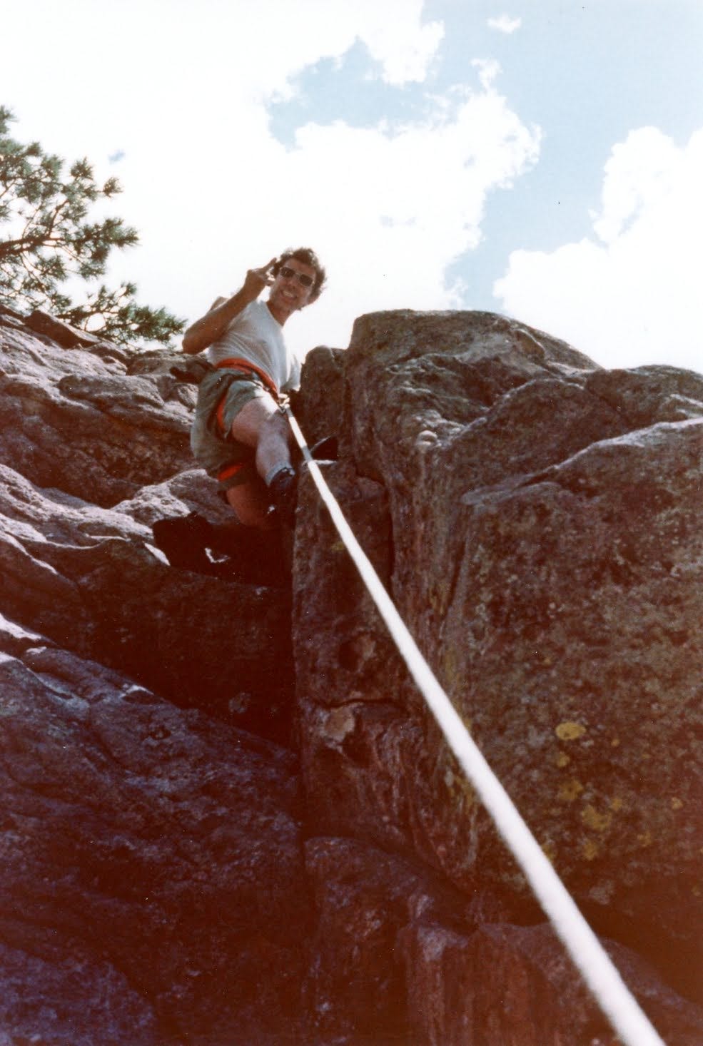 man on climbing rope making rude gesture