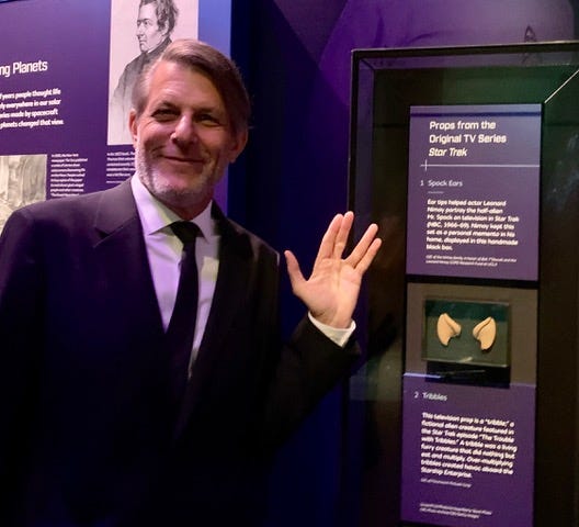 Adam Nimoy gives the "Vulcan Salute" next to the display of his dad Leonard Nimoy's Spock ear tips at the Smithsonian National Air and Space Museum.