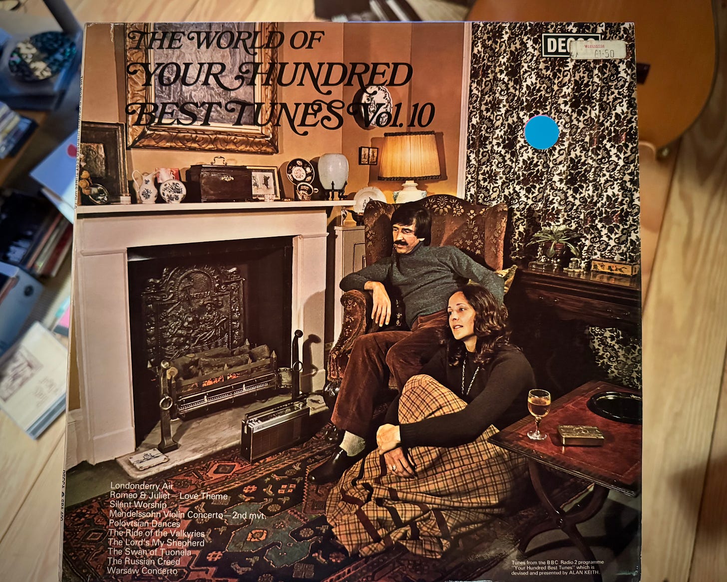 Album cover of The World of Your Hundred Best Tunes Vol. 10, with 70s couple chilling by the fireside.