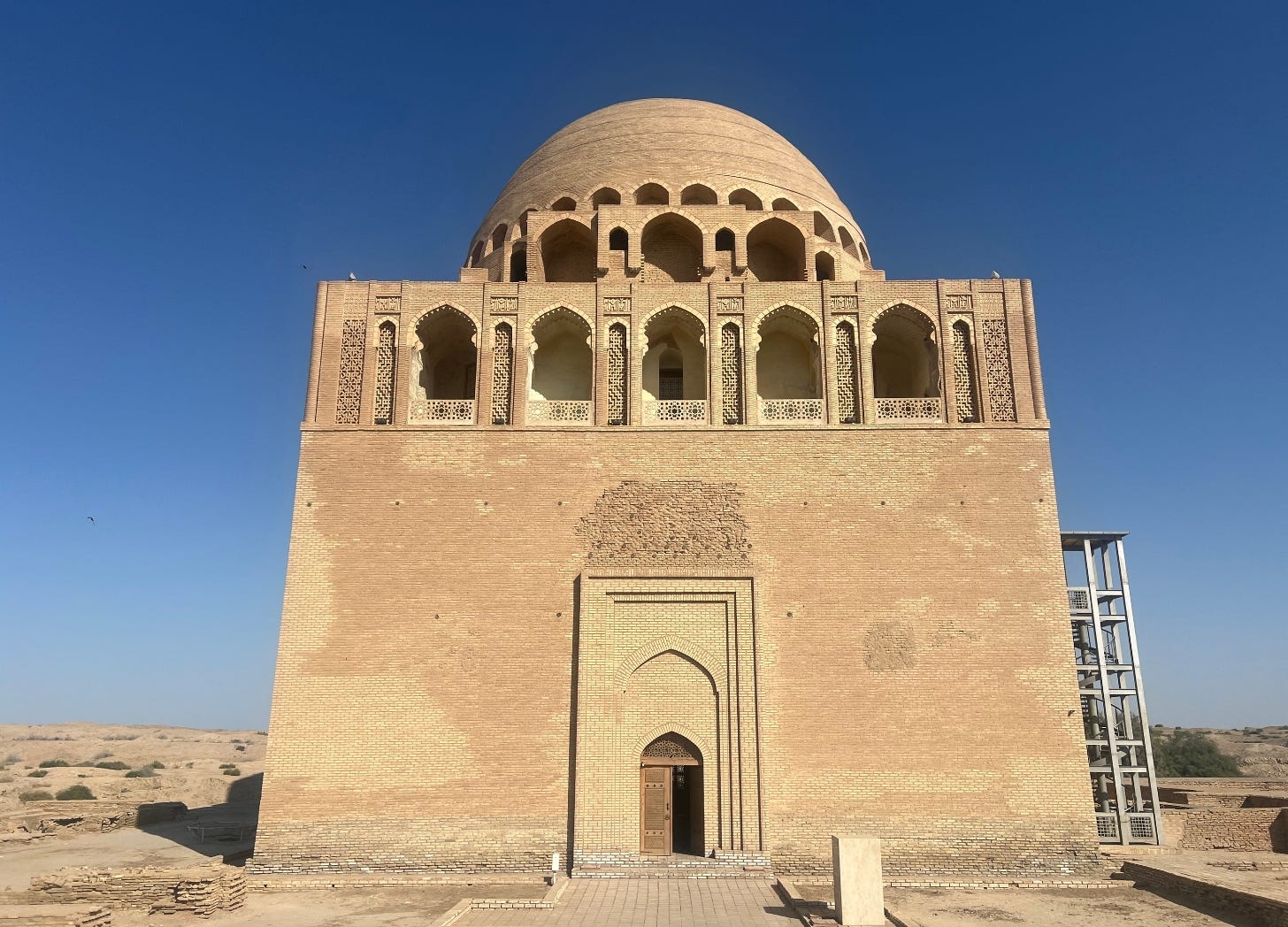 Sand-colored mausoleum against a bright blue sky. Sand-colored mausoleum against a bright blue sky.