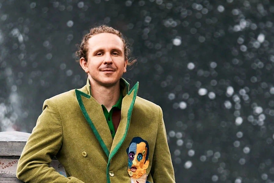 KidSuper, Colm Dillane, in his green corduroy jacket with a painted-face patch, snow in the air.