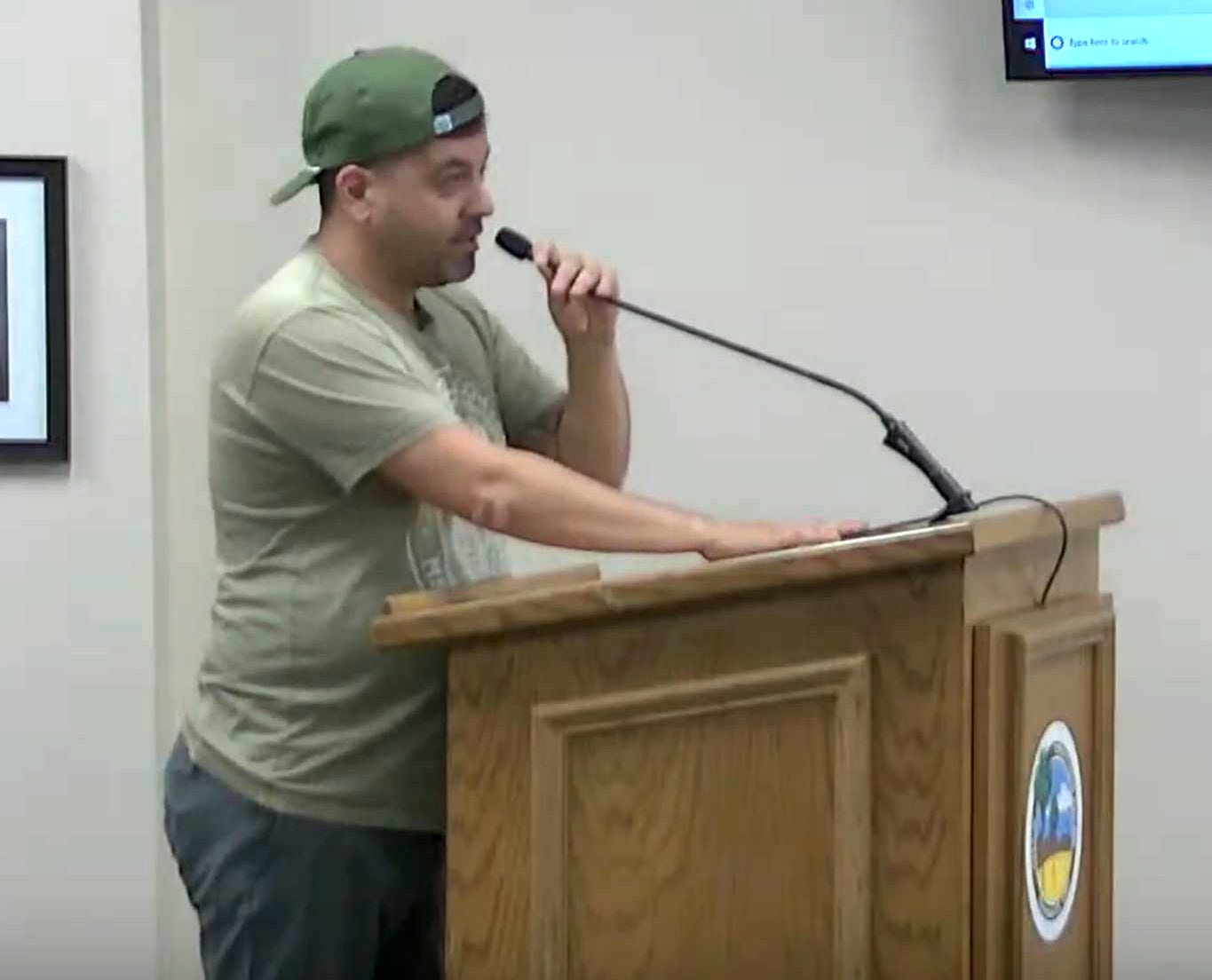 A person standing at a podium speaking into a microphone

AI-generated content may be incorrect.