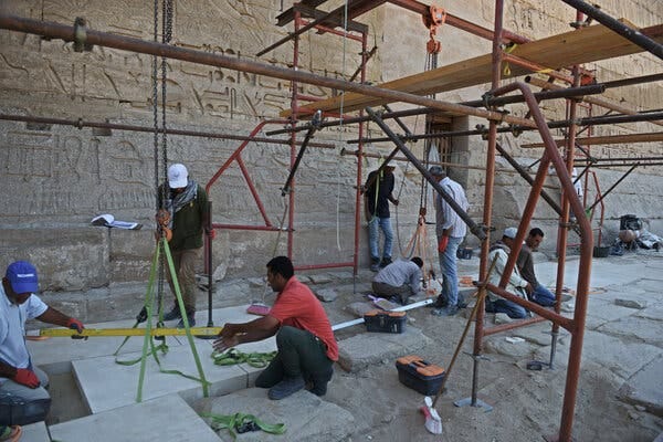 Workers replace damaged Pharaonic stones with new ones crafted by stonemasons on site this month at the Medinet Habu temple complex in Luxor. Workers replace damaged Pharaonic stones with new ones crafted by stonemasons on site this month at the Medinet Habu temple complex in Luxor.