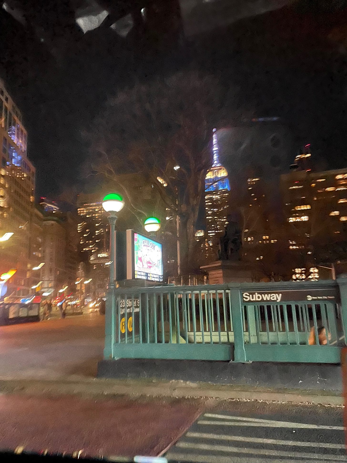 subway stop with empire state building in the background
