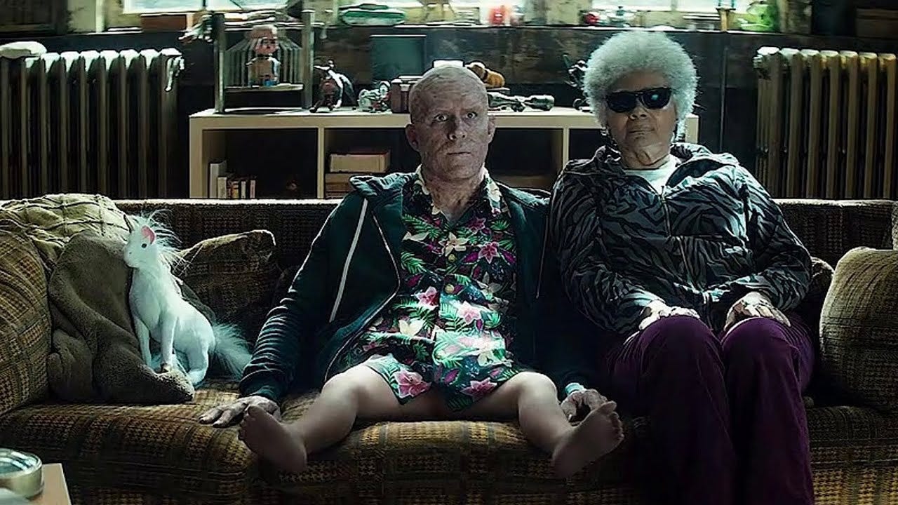 Wade Wilson sits beside Blind Al with newly regenerated, infant-sized legs after being torn in half. Wade Wilson sits beside Blind Al with newly regenerated, infant-sized legs after being torn in half.