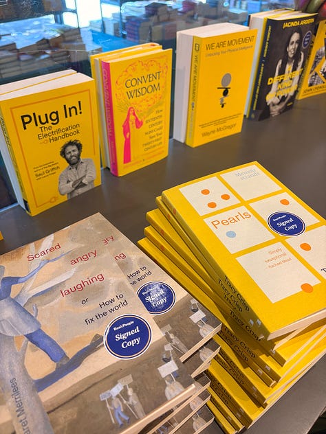 Books with signed stickers on them, a sleepy dog, and an event in a bookshop.