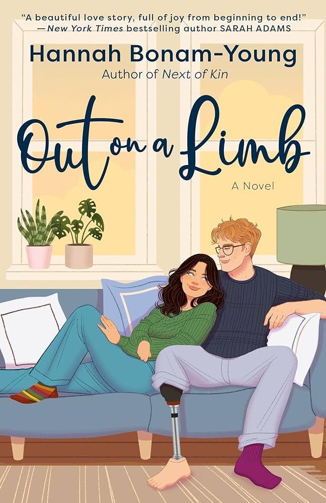 cover of out on a limb showing Win and Bo sitting on a couch together. Win is leaning on Bo and you can see her little hand and Bo's prosthetic leg.