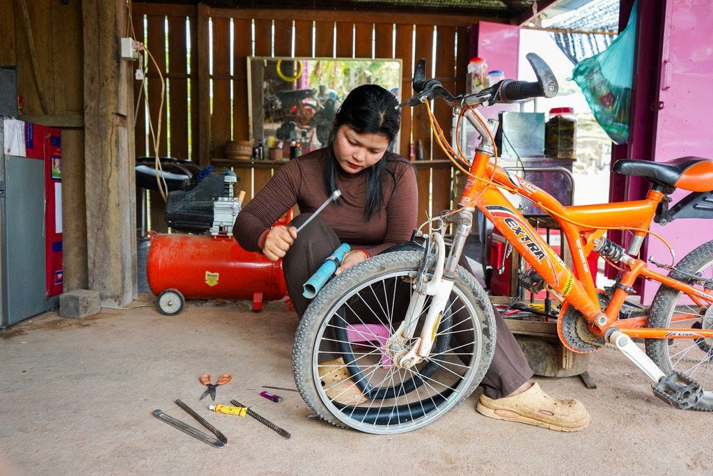 Kanada is repairing a bicycle