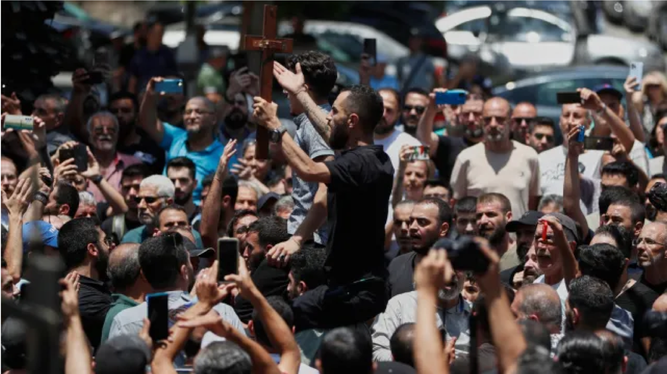 Mourners carry crosses and chant slogans during the funeral procession for victims of Sunday’s suicide bombing at Mar Elias Greek Orthodox Church, outside al-Saleeb Church in the al-Qasaa neighborhood of Damascus, Syria, Tuesday, June 24, 2025. (AP Photo/Omar Sanadiki)