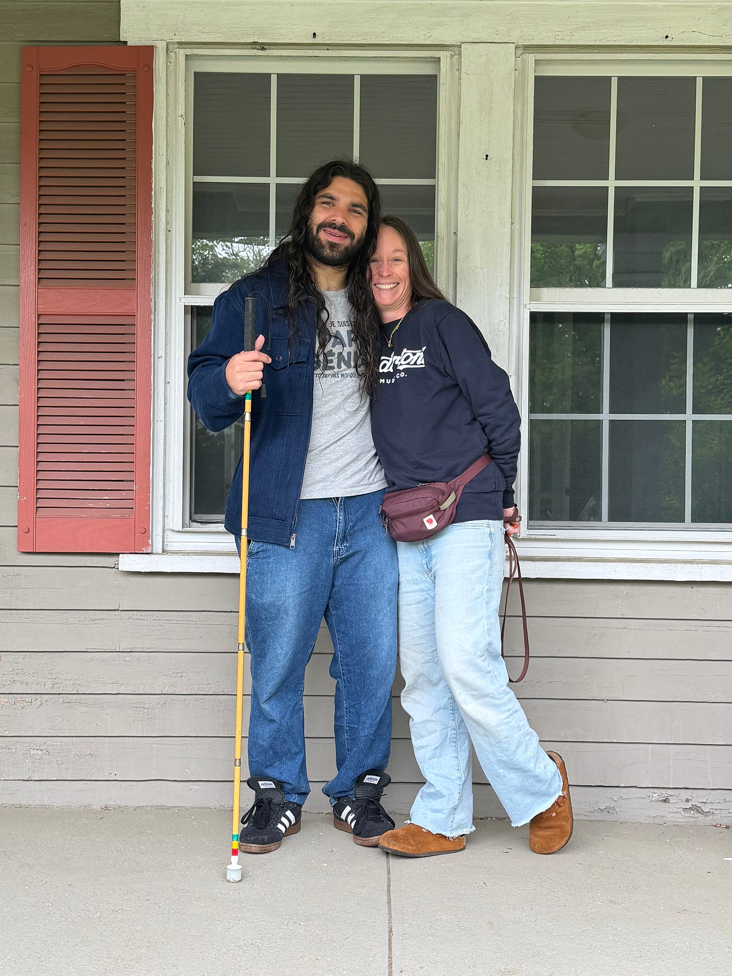 anthony and kelly ferraro with huge smiles on the day they closed for their house on the front porch of their new house