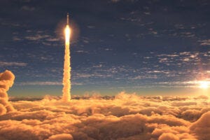 rocket flying past clouds