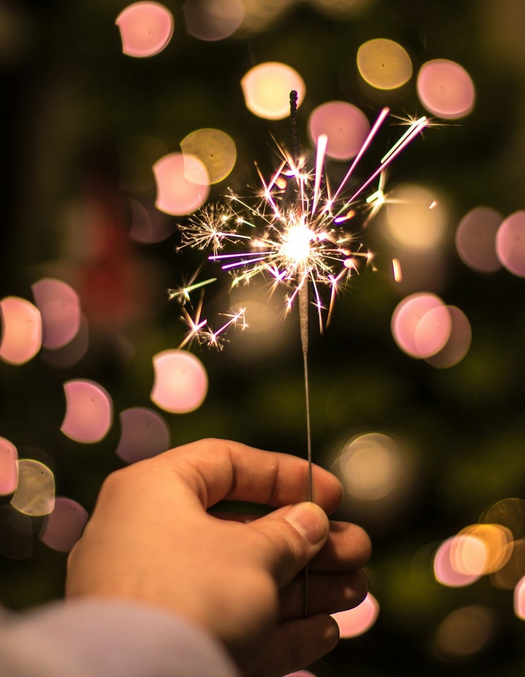 bokeh photography of person holding fireworks bokeh photography of person holding fireworks