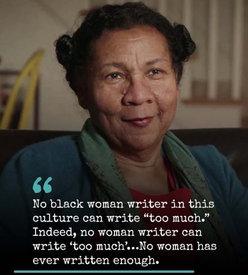Portrait of bell hooks smiling into the distance, captioned with one of her famous quotes, “No black woman writer in this culture can write “too much.” Indeed, no woman writer can write ‘too much’…No woman has ever written enough. 