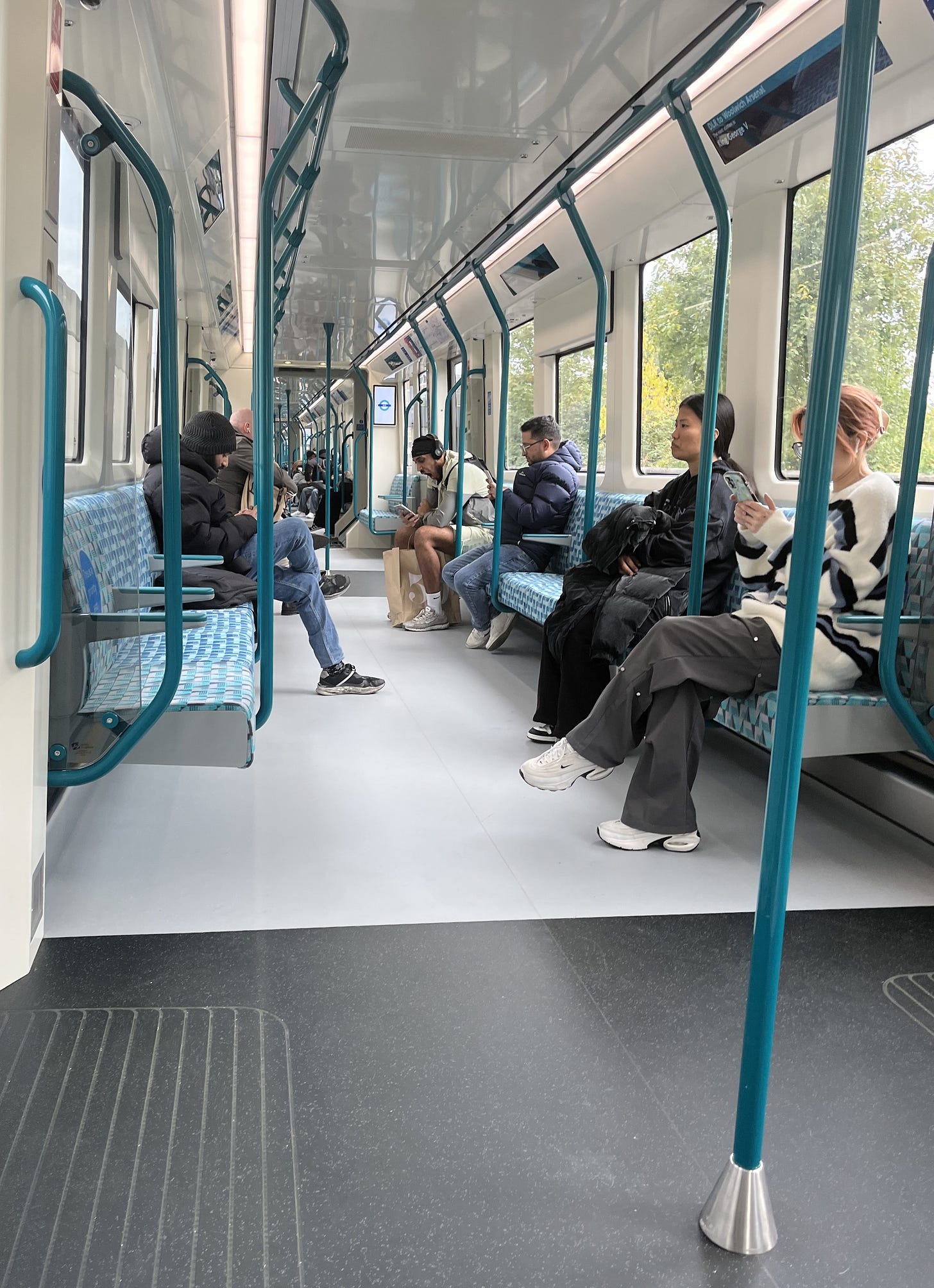 Photo showing interior of the train with various passengers.
