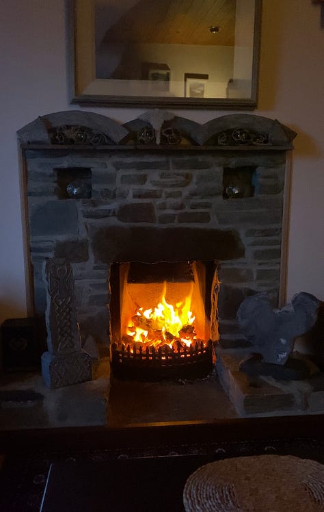 image one is my feet soaking in a tub filled with kelp. Image two is a beautiful Celtic fireplace fueled by peat moss. Image three is a woman standing joyfully along the cliffs on Cleggan