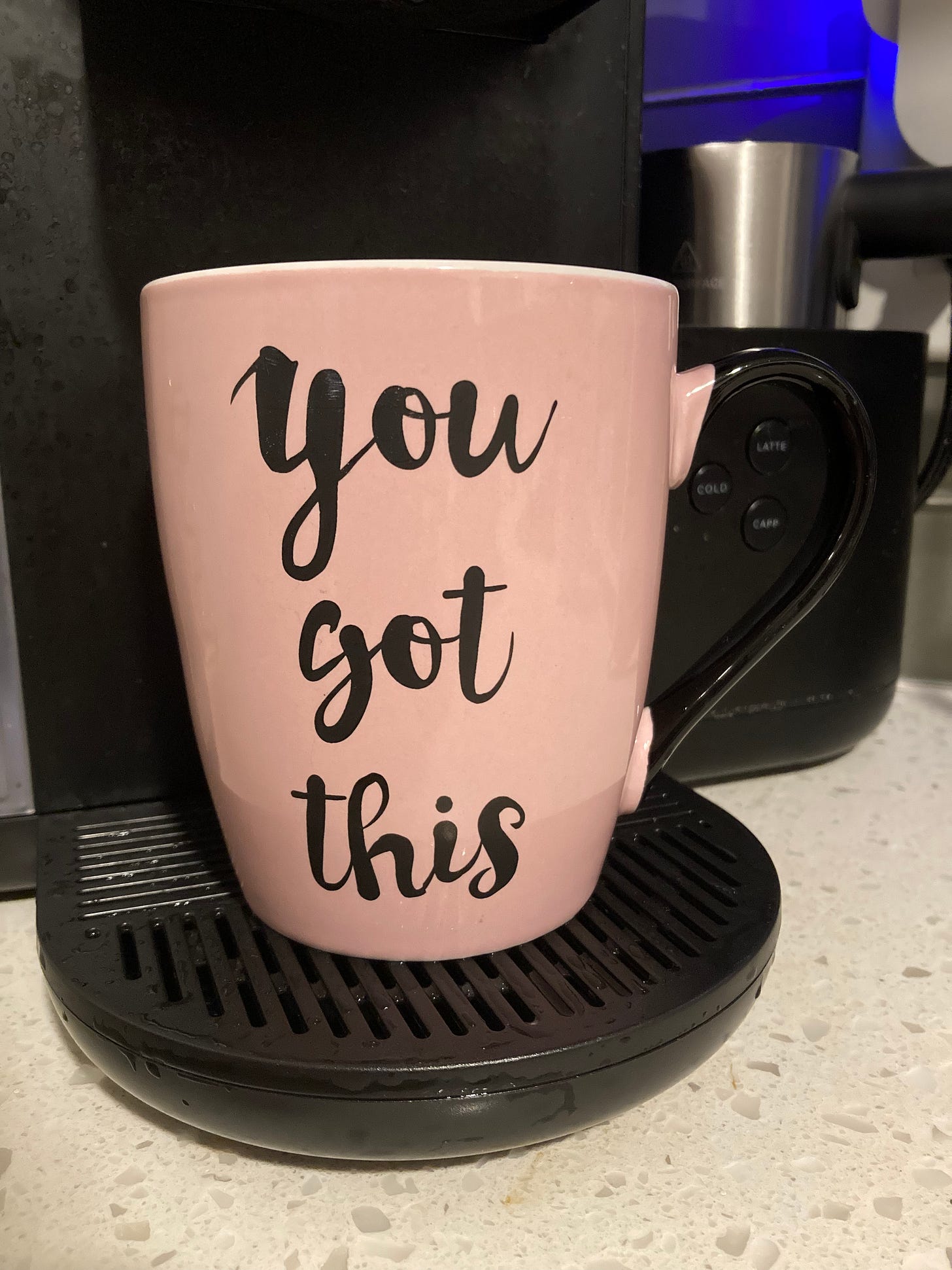 A pink mug with a black handle and "You got this" written in script font