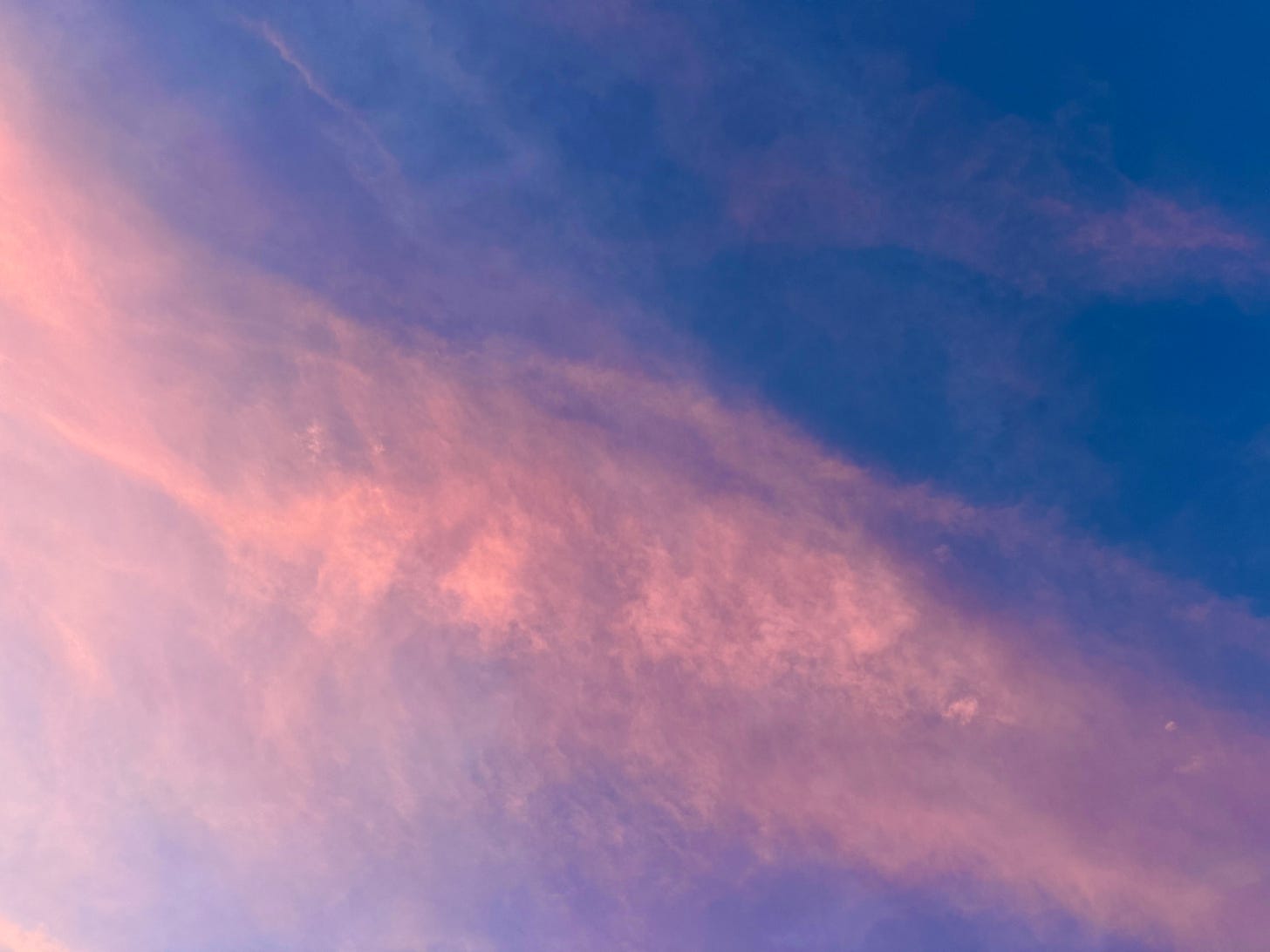 Pink clouds in blue sky
