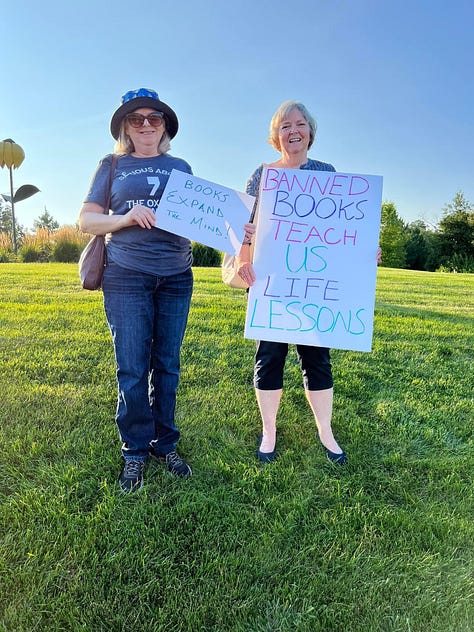 people holding signs in support of freedom of speech and access to information