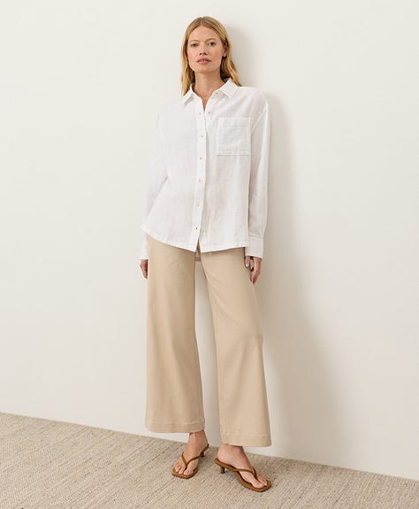 Various views of a model wearing the white longsleeve buttonfront linen shirt.