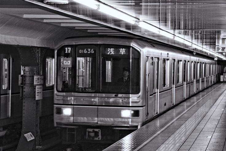 This may contain: a subway train pulling into a station with people waiting on the platform to board it