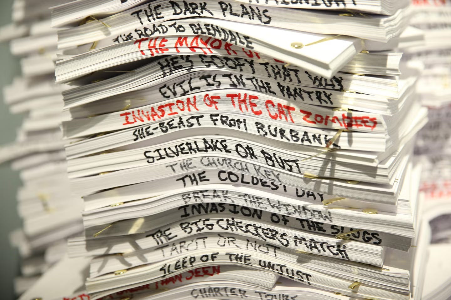 Multiple printed screenplays illustrating scriptwriting process