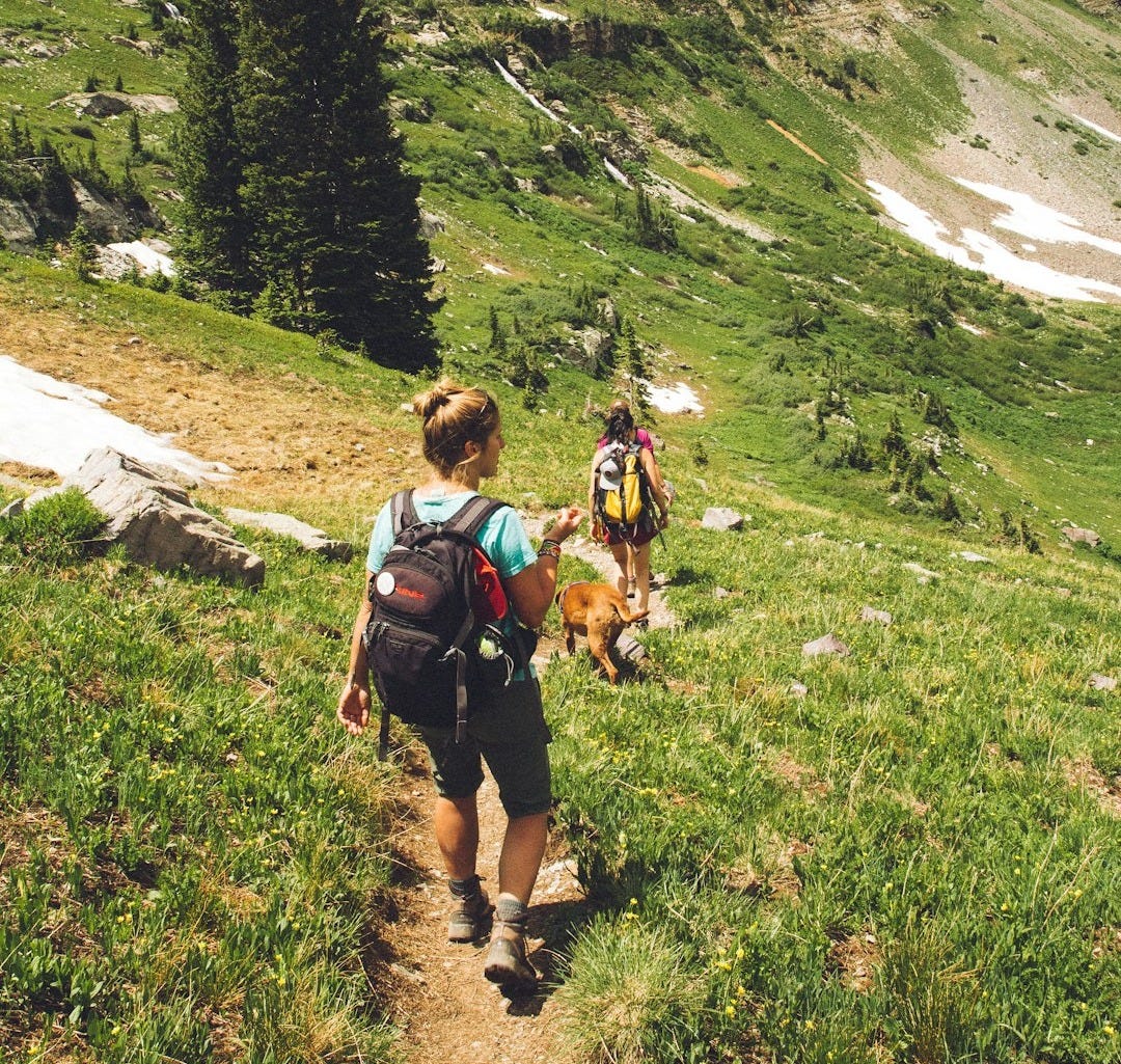 woman walking down the hill at daytime