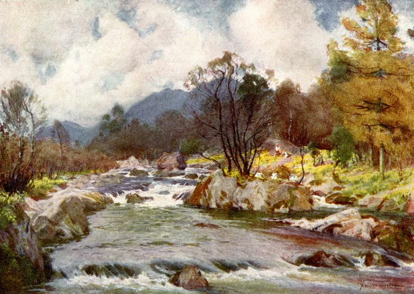 river, brown woodland, grey mountains behind