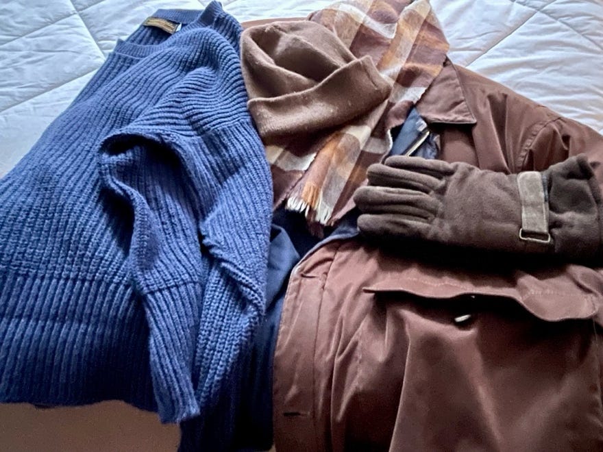 A pile of clothes on a bed

Description automatically generated