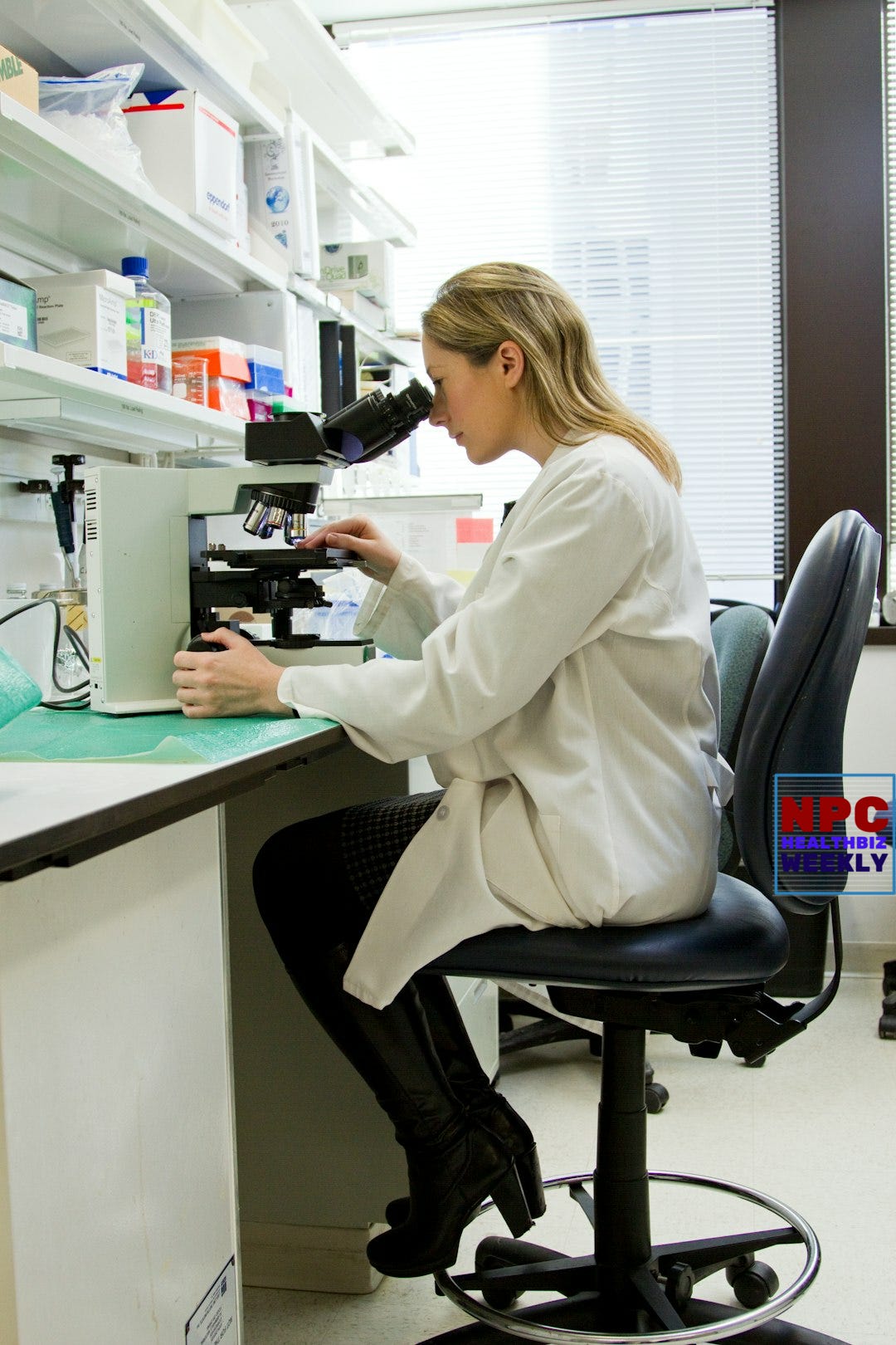 woman in white robe sitting on black office rolling chair